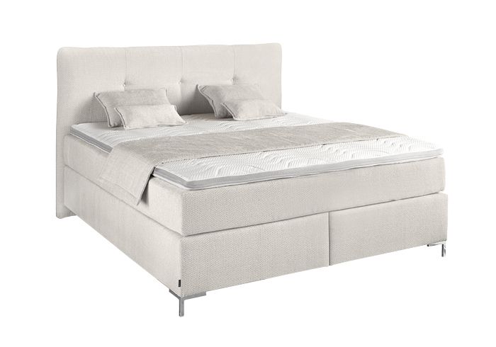 Helles Boxspringbett mit gestepptem Kopfteil und dekorativen Kissen Helles Boxspringbett mit gestepptem Kopfteil und dekorativen Kissen